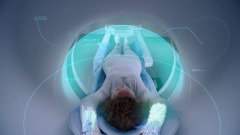 Woman undergoes MRI or CT scan, lies on bed inside the machine. Visual effects of scanning female patient brain and body. High-tech equipment in modern medical lab with augmented reality technologies.